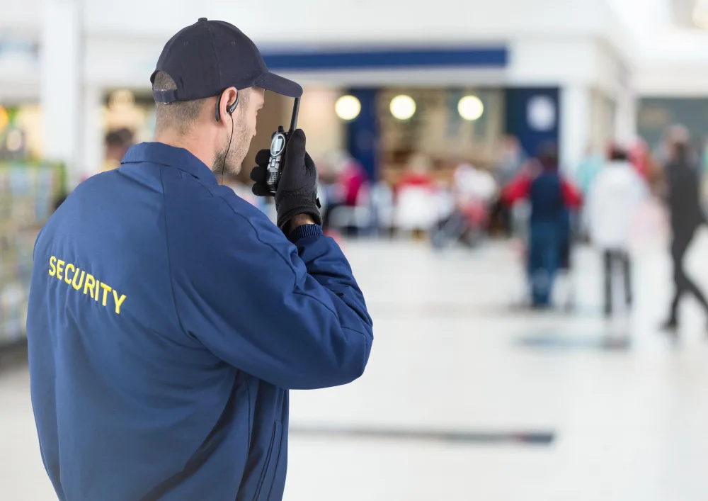Security guy talking on radio in a mall